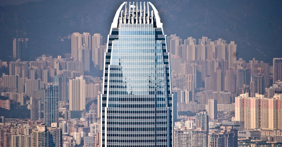 View of a prominent Hong Kong skyscraper with a bustling urban cityscape backdrop.
