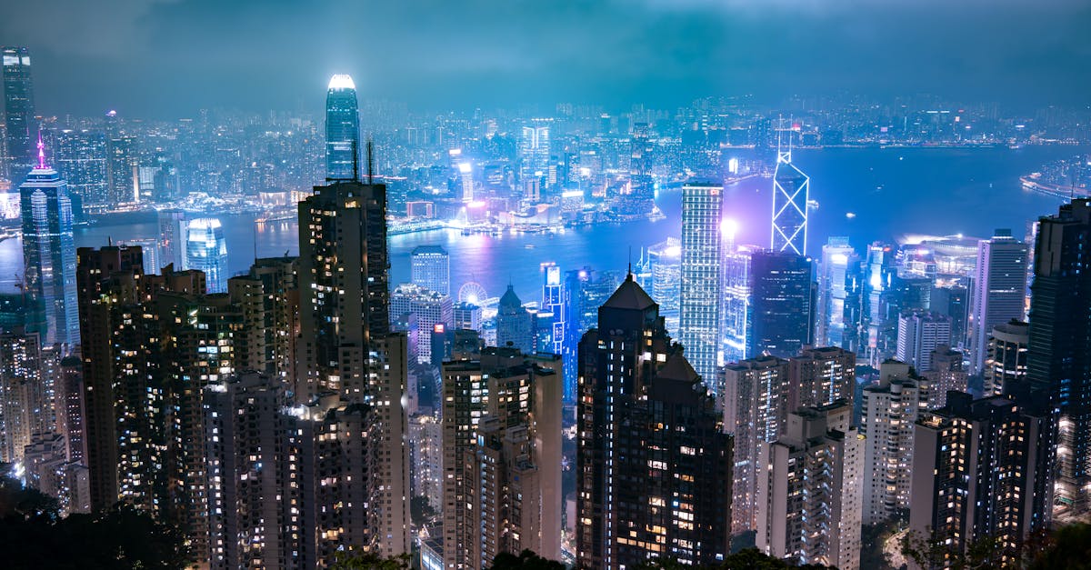 Captivating night view of Hong Kong's skyline, showcasing illuminated skyscrapers and Victoria Harbour.