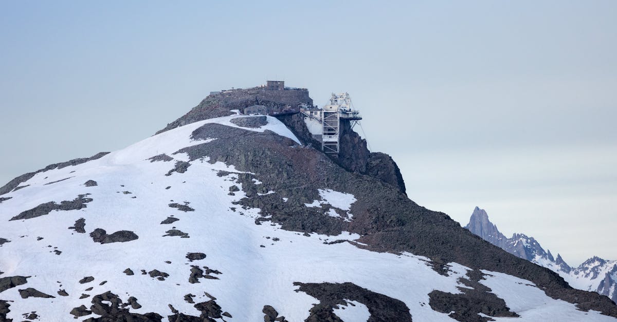 Snow-covered mountain peak with an observation structure, capturing the rugged beauty of the Alps in winter.