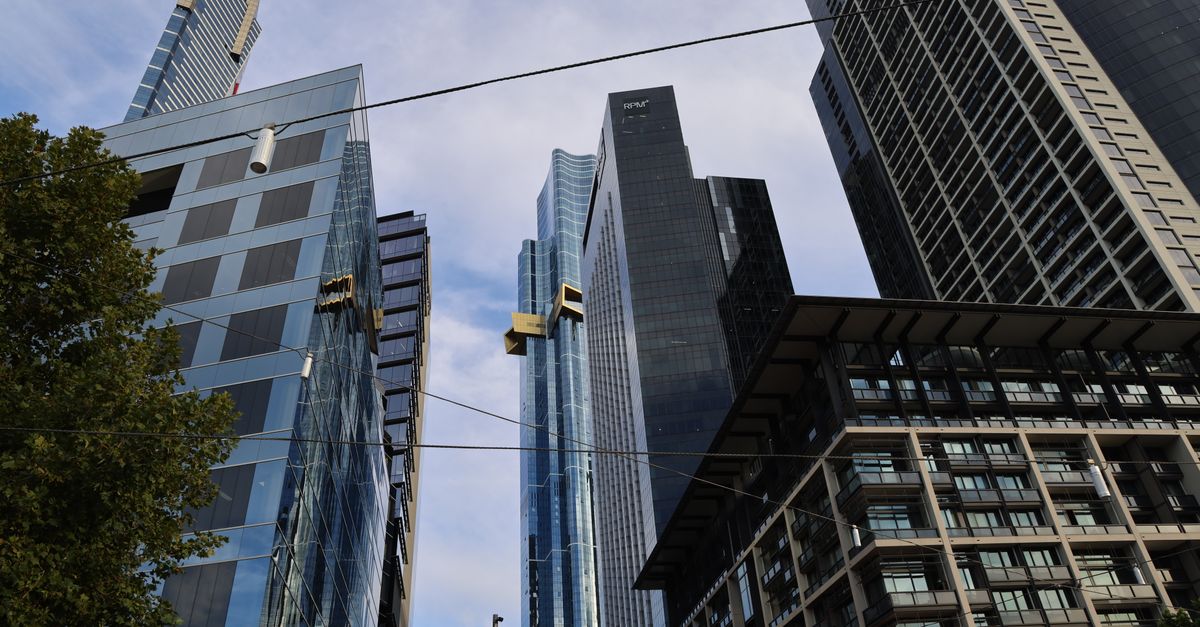 View of towering skyscrapers against a blue sky in a modern city.