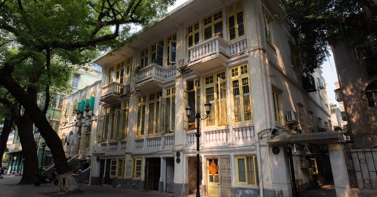 European-style building surrounded by trees, showcasing architectural elegance in a serene outdoor setting.