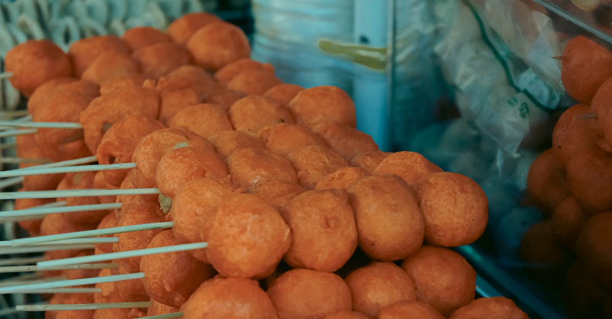 Close-up of skewered fried street food balls, perfect for food and travel visuals.