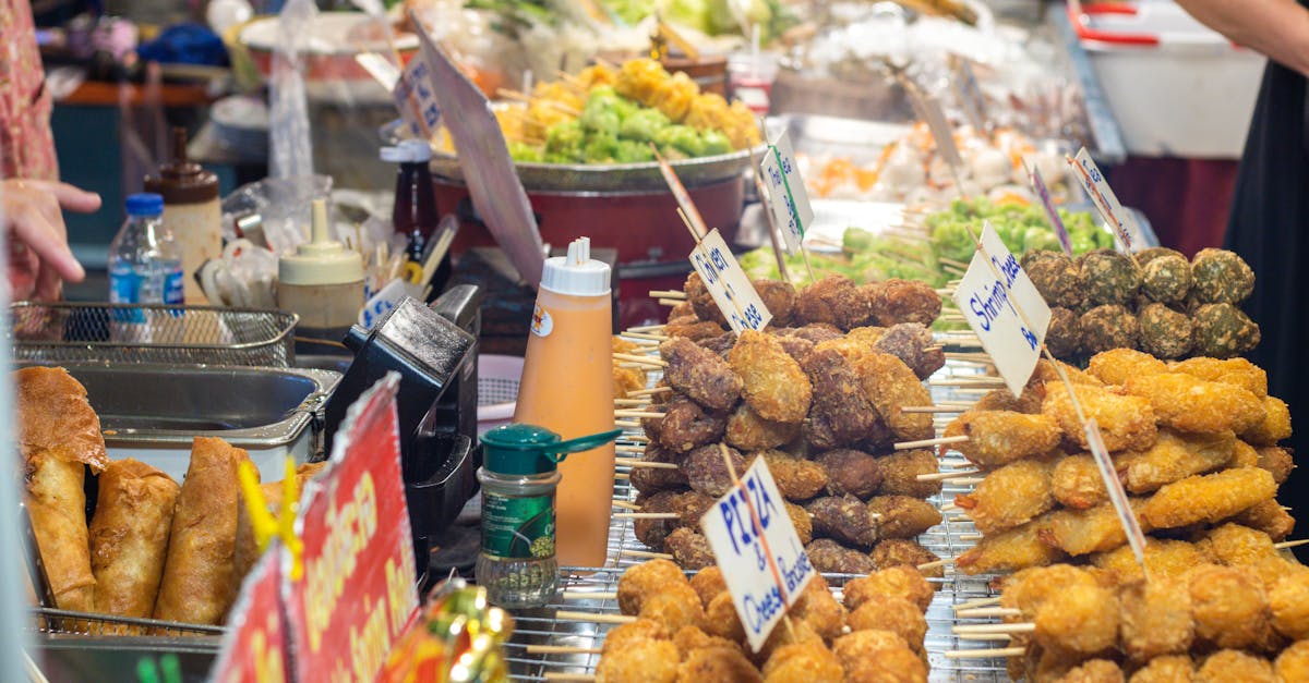 A vibrant street food stall offering a variety of skewers and snacks in a busy market setting.