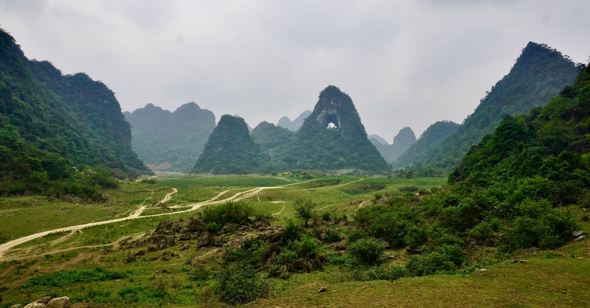 Explore the serene landscape of Angel Eye Mountain with lush green karst formations in Cao Bang, Vietnam.