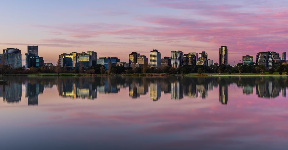 Captured at twilight, this skyline reflects beautifully in a tranquil lake.