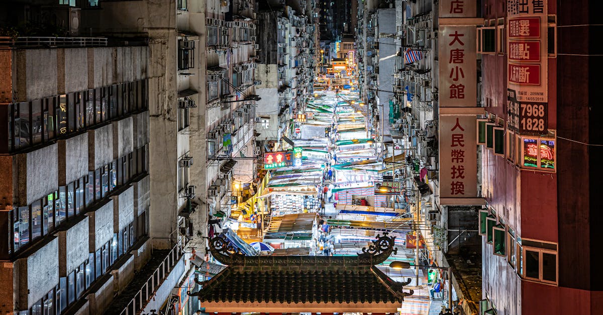 Explore the lively atmosphere of Hong Kong's night market with crowded stalls and neon lights.