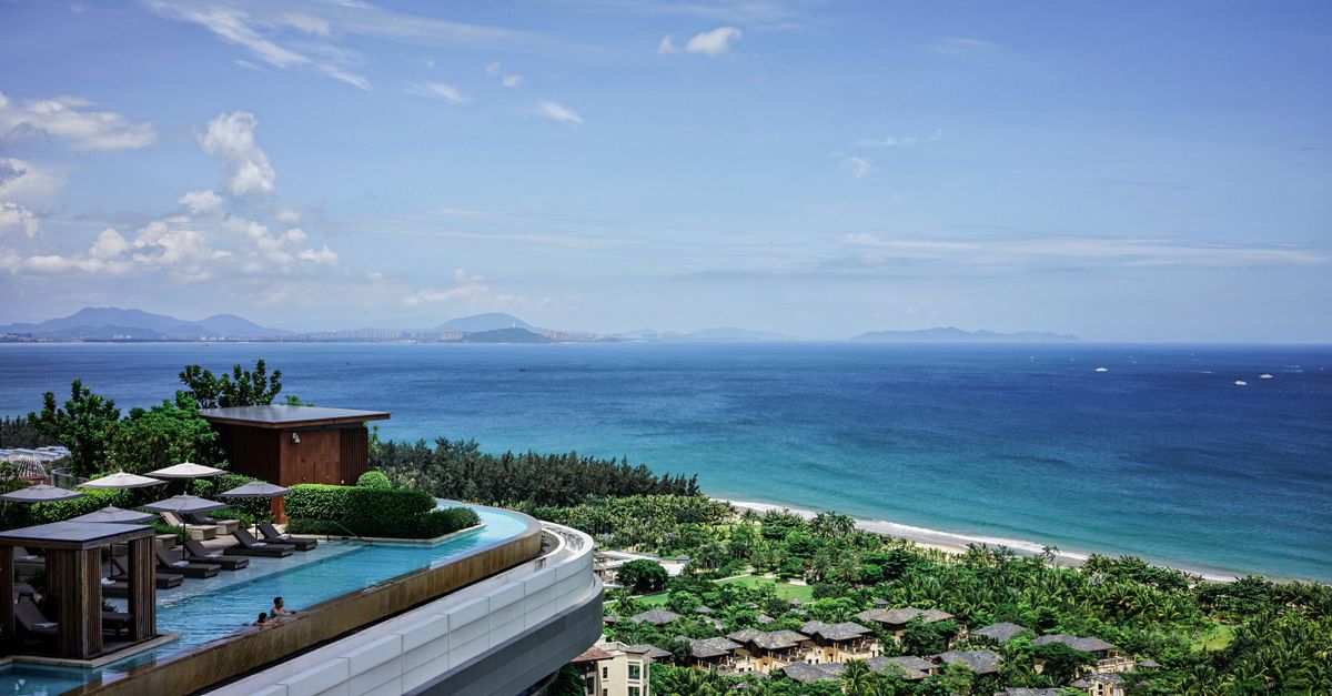 Stunning seaside resort with infinity pool overlooking the tropical ocean landscape.