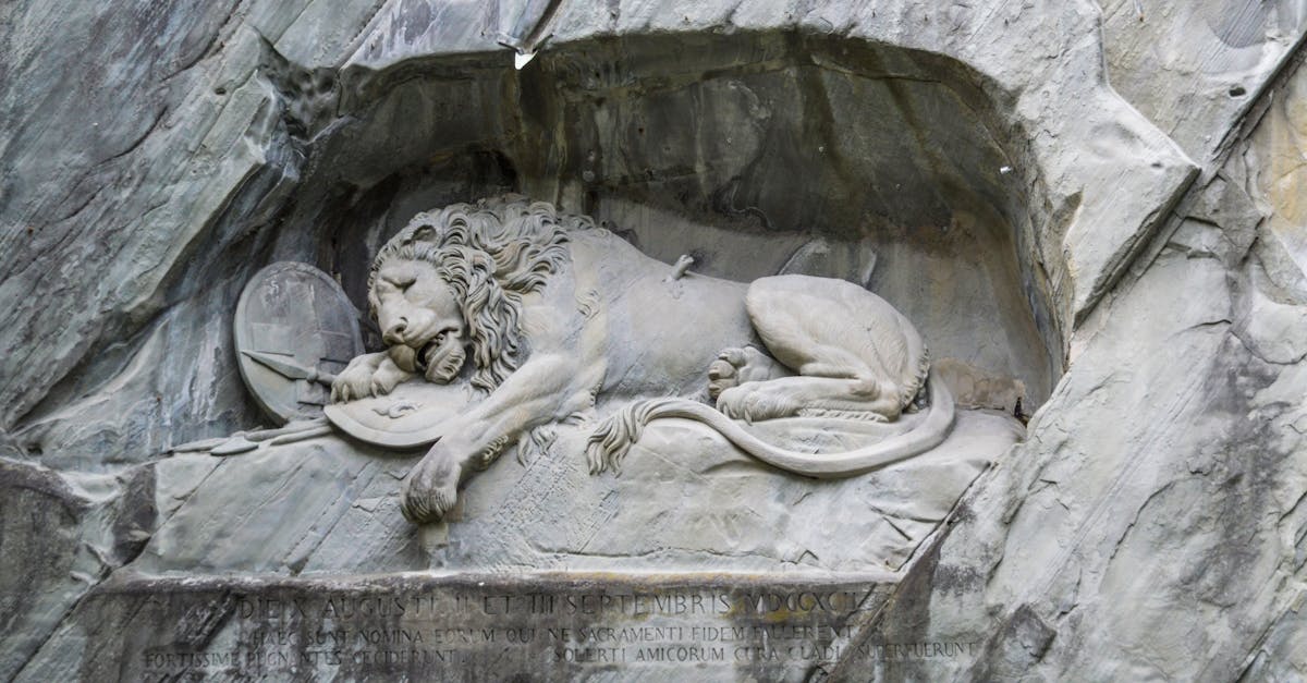Old stone sculpture of Lion of Lucerne commemorating Swiss Guards who were massacred at Tuileries in 1792