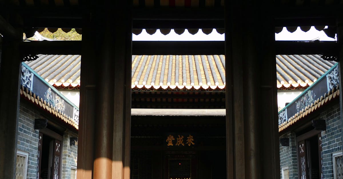 Gate leading to yard of ancient Buddhist shrine on sunny day in Hong Kong