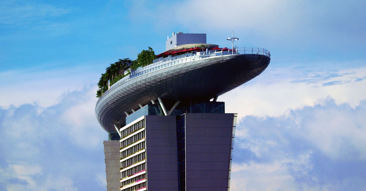 The Marina Bay Sands SkyPark against a clear blue sky in Singapore.