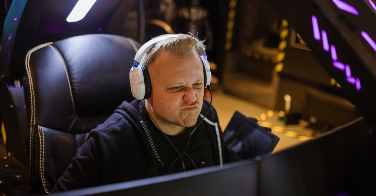Focused gamer wearing headphones intensely playing an online esports game indoors.