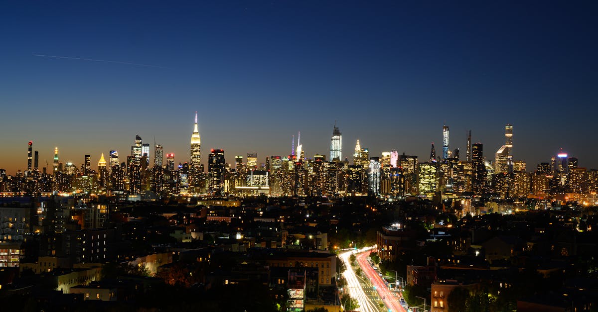 Captivating view of New York City's skyline at night with iconic skyscrapers and bright city lights.