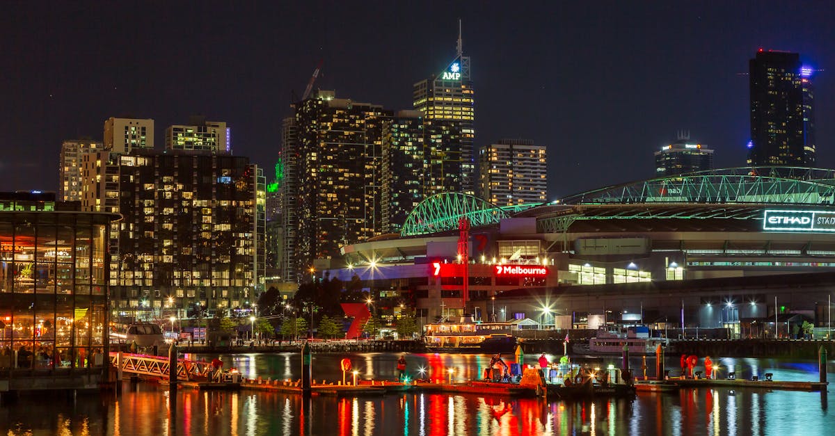 Illuminated Melbourne waterfront cityscape at night showcasing vibrant urban life and architecture.