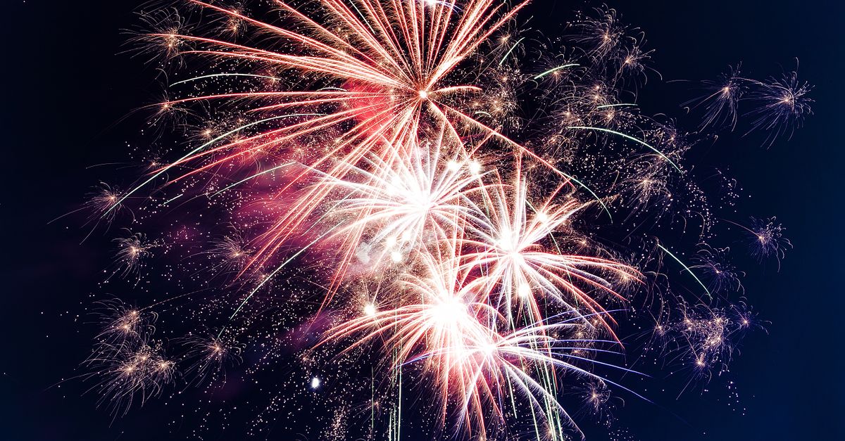 Colorful fireworks exploding in the night sky creating a festive atmosphere.