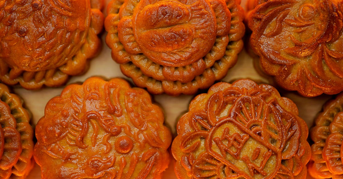Delicious traditional mooncakes with intricate designs in a flat lay arrangement.
